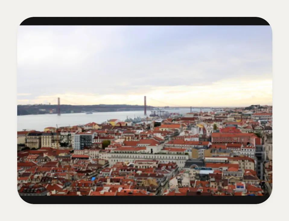 Kasbu Flickr card showing a photo of the rooftops of Lisbon with the 25 de Abril bridge in the distance